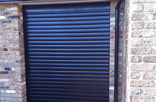 A Gliderol 77mm insulated Roller shutter garage door. In Black with matching guides and a matching full box. Fitted in Farnborough. Hampshire.