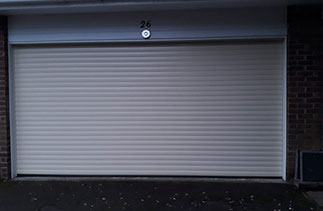 A Gliderol 77mm insulated Roller shutter garage door. In Light Ivory with White guides and a white full box. Fitted in Camberley. Surrey.