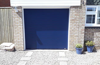 A Sws Seceuroglide compact roller shutter garage door. In Navy Blue with White guides and a white full box. Fitted in Staines. Surrey.