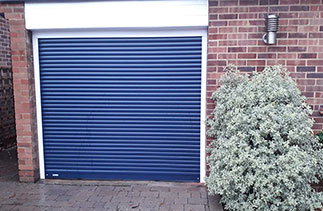 A Sws Seceuroglide compact roller shutter garage door. In Navy Blue with White guides and White full box. Fitted in Woking. Surrey.