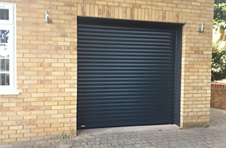 A Sws Seceuroglide Excel roller shutter garage door. In Anthracite Grey with matching guides and a matching full box. Fitted in Camberley. Surrey.