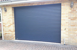 A Sws Seceuroglide Excel roller shutter garage door. In Anthracite Grey with matching guides and a matching full box. Fitted in Camberley. Surrey.