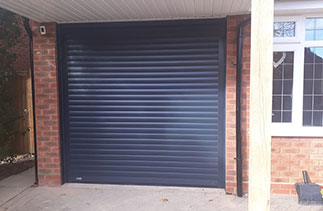 A Sws Seceuroglide Excel roller shutter garage door. In Anthracite Grey with matching guides and a matching full box. Fitted in Lightwater. Surrey.
