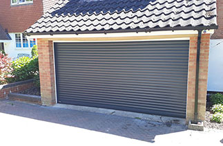 A Sws Seceuroglide Excel roller shutter garage door. In Anthracite Grey with white guides and a White full box. Fitted in Camberley. Surrey.