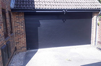 A Sws Seceuroglide Excel roller shutter garage door in Black. With matching guides and a matching full box. Fitted in Yatley. Hampshire.