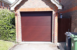 A Sws Seceuroglide Excel roller shutter garage door. In Mahogany with matching guides and a matching box. Fitted in Camberley. Surrey.