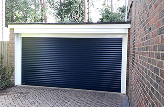 A Sws Seceuroglide Excel roller shutter garage door. In Navy Blue with White guides and a white full box. With White Pvc. Fitted in Fleet. Hampshire.