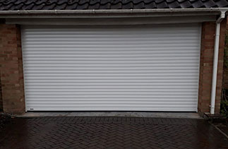 A Sws Seceuroglide Excel roller shutter garage door. In White with White guides and a white full box. Fitted in Camberley. Surrey.