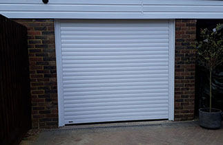 A Sws Seceuroglide Excel roller shutter garage door. In White with White guides and a white full box. Fitted in Woking. Surrey.
