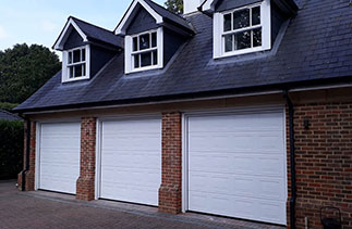 Three Gardor 40mm insulated sectional garage doors. In the Georgian style. In White. Fitted in Ascot. Berkshire.