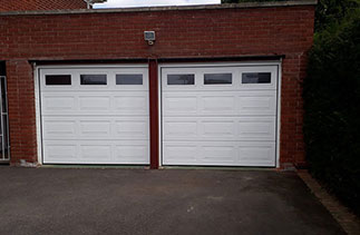 Two Carteck 40mm insulated sectional garage doors. In the Georgian style in White. With Windows. Fitted in Wargrave. Berkshire.