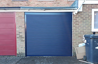 A Navy Blue 55mm compact roller shutter garage door with matching guides and full box. Garage door fitted in Backwater, Surrey.