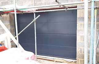 A Carteck Solid rib sectional garage door in Anthracite Grey. Fitted in Guildford. Surrey.