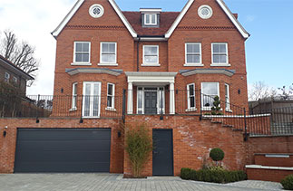 A Carteck Solid rib style sectional garage door in a Anthracite smooth finish. Fitted in Guildford, Surrey.
