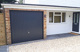 A Garador Carlton style steel up and over garage door. In Anthracite Grey with a matching frame and PVC. Complete with a Brushed steel handle. Fitted in Sandhust, Berkshire.