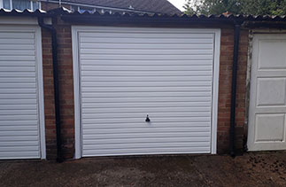 A Garador steel up and over Horizon style garage door in White with a matching steel frame. Fitted in Woking, Surrey.
