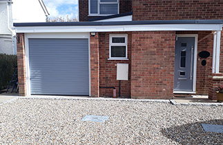 A Sws Seceuroglide Excel insulated Roller Shutter garage door in a Ral colour to match the front door. Fitted in Woking, Surrey.