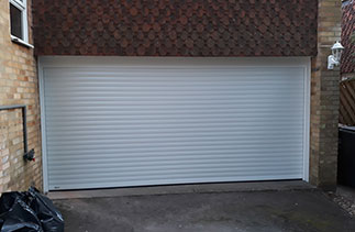 A Sws Seceuroglide roller shutter garage door in White. Fitted in Camberley, Surrey