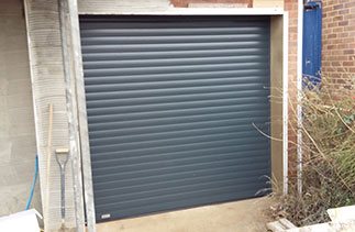 A Anthracite Seceuroglide Excel insulated roller shutter garage door fitted in Ottershaw, Surrey.