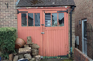 Before the installation of a new set of Wessex GRP side hinged garage doors in Camberley, Surrey.