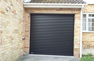 A Black insulated roller shutter garage door fitted in Camberley, Surrey