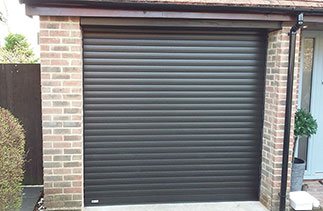 A Black Wood grain Seceuroglide Excel insulated roller shutter garage door supplied with white internal slats. Fitted in Bagshot, Surrey.