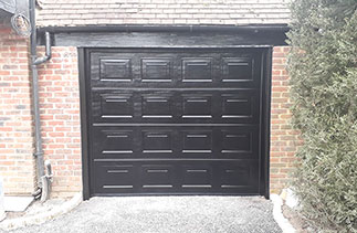 A Carteck Georgina sectional garage door in Black woodgrain. Fitted in Egham, Surrey.