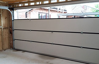 Further assembling of a Carteck sectional garage door. Fitted in Wokingham, Berkshire.