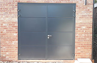 A set of Carteck insulated Solid rib side hinged garage doors in Anthracite Grey (Smooth finish) with No branding badge and stainless steel handle and lock cover. Fitted in Surbiton, Surrey.
