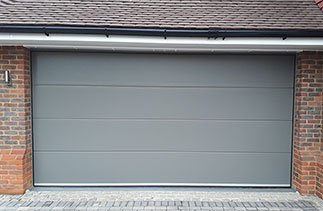 A Carteck Solid ribbed 40mm sectional garage door in Umbra Grey. Fitted in East Horsley, Near Leather head. Surrey.