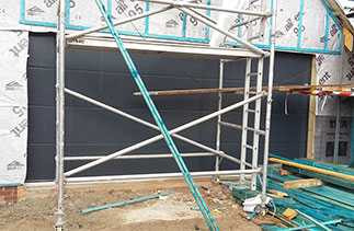 A Carteck Solid ribbed garage door in Anthracite, Fitted behind the timber construction. Fitted in Wokingham, Berkshire. Excellent service and attention to detail. Very proactive in terms of responding to questions and working with my builder to ensure size was correct and installation went smoothly. Keith Miller.