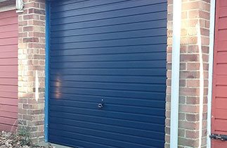 A Garador Horizon canopy garage door finished in steel Blue fitted in Mytchet Surrey