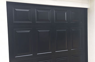 A Garador Beaumont in Black with a Black steel frame. Door was supplied with No handle hole because it is electronically operated. We also installed a new white shiplap upvc fascia. Door fitted in Church Crookham, Hampshire.