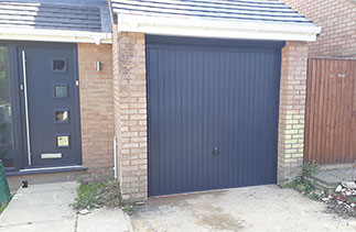 A Garador Carlton up and over garage door in Anthracite Grey with a matching steel frame. Fitted in Frimley, Surrey.