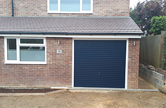 A Garador Horizon steel up and over garage door. In Dark Blue with a White steel frame. Fitted in Camberley, Surrey