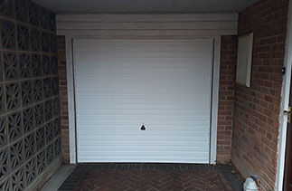 A Garador Horizon white steel up and over garage door. Fitted to the existing timber frame, on canopy door gear. Garage door fitted in Camberley, Surrey.