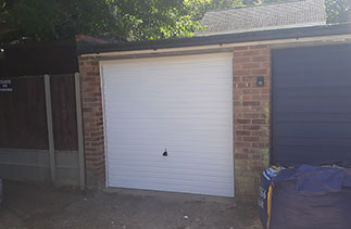 A Garador Horizon white up and over garage door with a white steel frame. Fitted in Camberley, Surrey.