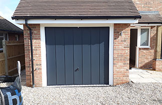 A Garador steel range Windsor style up and over garage door in Anthracite Grey. Fitted to a timber frame. Garage door fitted in Basingstoke, Hampshire.
