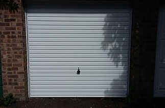 A Garador White steel up and over garage door, fitted on retractable plus door gear with a white steel frame. Door fitted in Camberley, Surrey.