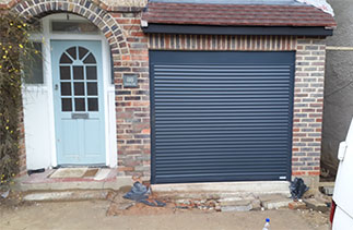 A Gliderol 55mm compact roller shutter garage door in Anthracite Grey, with matching guides and a matching full box. Garage door fitted in Addlestone, Surrey