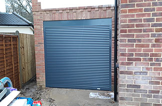A Gliderol 55 compact insulated roller shutter garage door in Anthracite fitted between the opening. Fitted in Esher, Surrey.