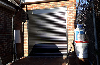 A Gliderol 55mm compact roller shutter garage door in Black with a full box and matching guides. Garage door fitted in Ascot, Berkshire.