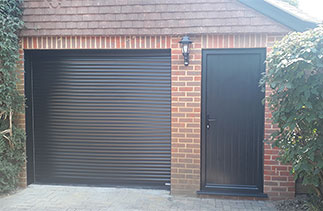 A Gliderol Black 55mm compact roller shutter garage door and a Black side garage door. Fitted in Guildford. Surrey.