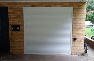 A Gliderol White 55 compact insulated roller shutter garage door fitted within the opening. Fitted in Blackwater, Surrey.