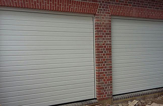 Two of Three Hormann S – ribbed sectional garage doors in Ral 9001. Fitted behind the structural openings. Fitted in Beaconsfield, Buckinghamshire