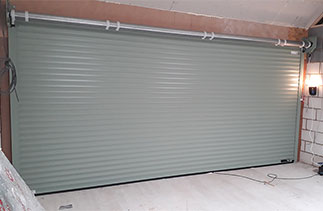 The inside view of a Sws Seceuroglide Excel Roller Shutter garage door fitted with no internal box. Fitted in Woking, Surrey.
