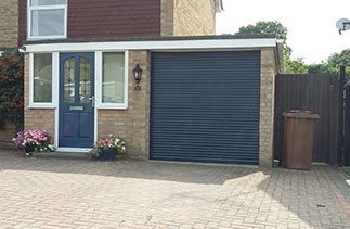 A Blue 55mm compact roller shutter garage door, fitted with matching guides and a matching full box. Fitted in Frimley, Surrey.