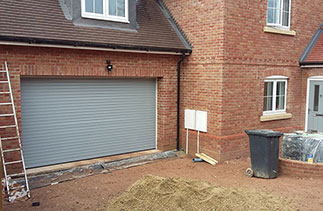 A Seceuroglide Excel roller shutter garage door supplied in Ral 7042 to match the front door. Fitted to plot 4 in Alton, Hampshire.