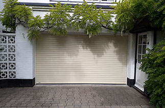 A Sws Seceuroglide Excel insulated roller shutter garage door in Ivory. Fitted in Camberley, Surrey.