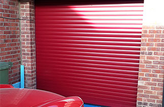A Sws Seceuroglide Excel insulated roller shutter garage door in Burgundy. Fitted in Frimley, Surrey.